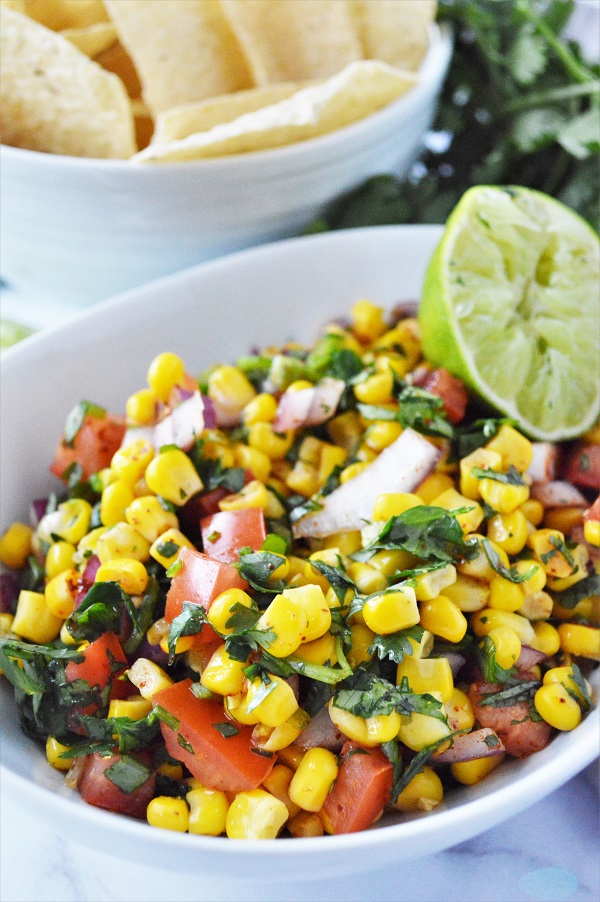 This Fresh Corn Salsa recipe is a little sweet, tangy and spicy. It's the perfect condiment to your burritos, salads, tacos and more!
