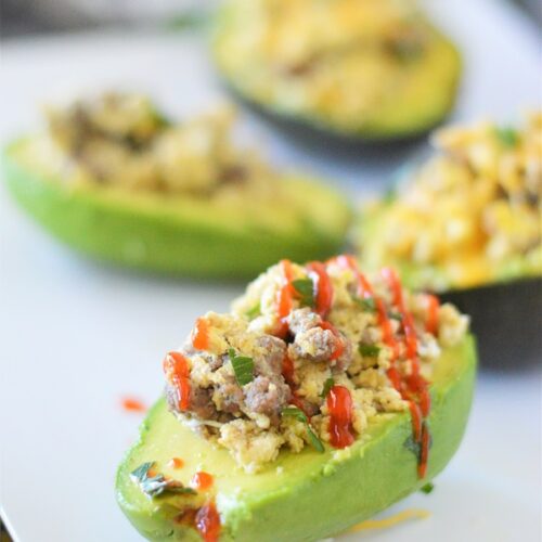Seasoned eggs, sausage, and cheese all piled high into a ripe avocado.  It's such a simple recipe, but will absolutely wow you with flavors.