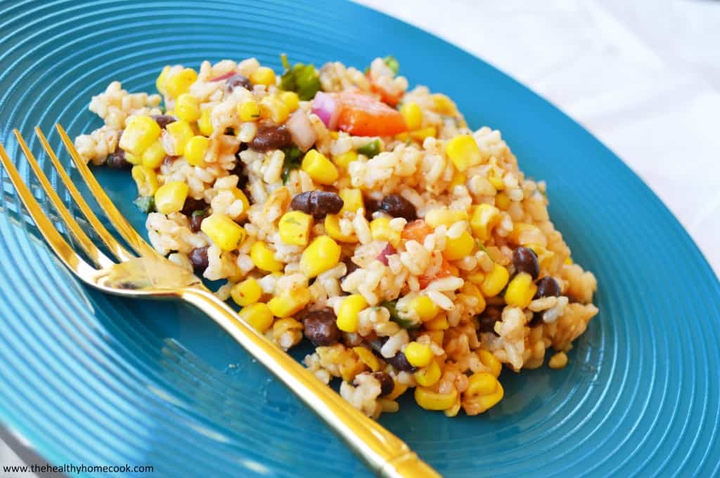 This Southwest Rice Salad, kicked up a notch with zesty jalapenos, corn, peppers and black beans, is anything but boring!  It will turn your next meal into a fiesta!