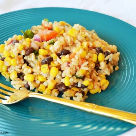This Southwest Rice Salad, kicked up a notch with zesty jalapenos, corn, peppers and black beans, is anything but boring!  It will turn your next meal into a fiesta!