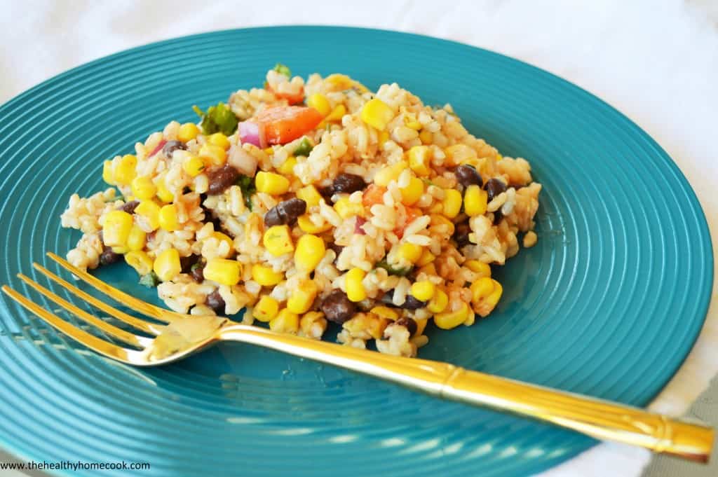 This Southwest Rice Salad, kicked up a notch with zesty jalapenos, corn, peppers and black beans, is anything but boring!  It will turn your next meal into a fiesta!