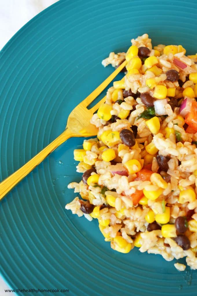 This Southwest Rice Salad, kicked up a notch with zesty jalapenos, corn, peppers and black beans, is anything but boring!  It will turn your next meal into a fiesta!
