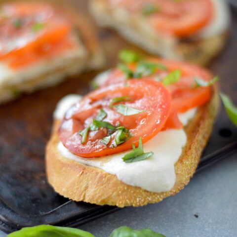 Grilled Caprese Toast. Charred rustic toast, topped with melted mozzarella, fresh tomatoes and a drizzle of balsamic. Perfect all year!