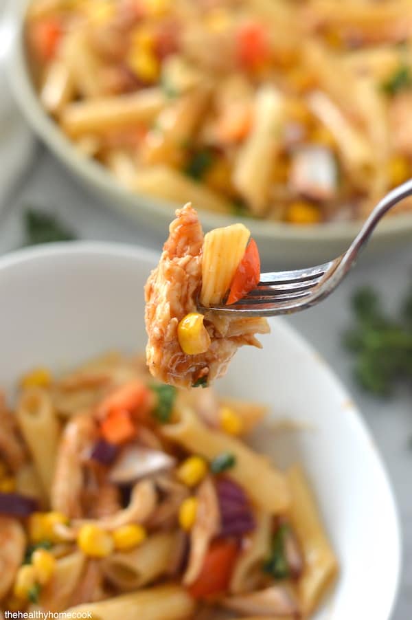 Close up image of finished bbq chicken pasta on fork.
