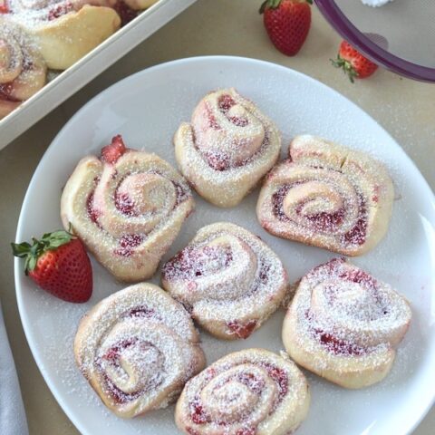 Strawberry Sweet Rolls are perfect for brunch or any holiday. Each roll is fluffy, fruity, and dusted with a light layer of powdered sugar.