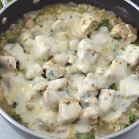 This Cheesy Salsa Verde Chicken & Rice Skillet is an easy one-pan meal, full of fresh ingredients and big flavor!