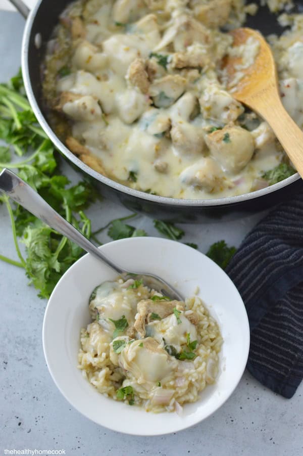 This Cheesy Salsa Verde Chicken & Rice Skillet is an easy one-pan meal, full of fresh ingredients and big flavor!