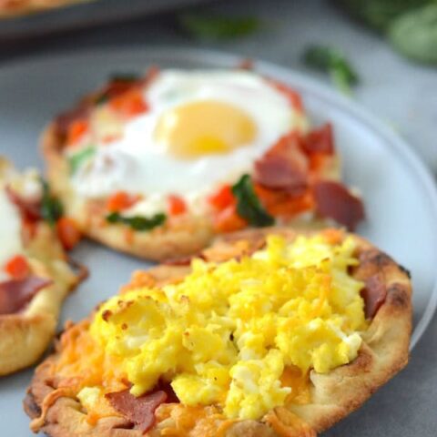 These homemade Mini Breakfast Pizzas are topped with your favorite morning essentials. Perfect for breakfast or dinner!