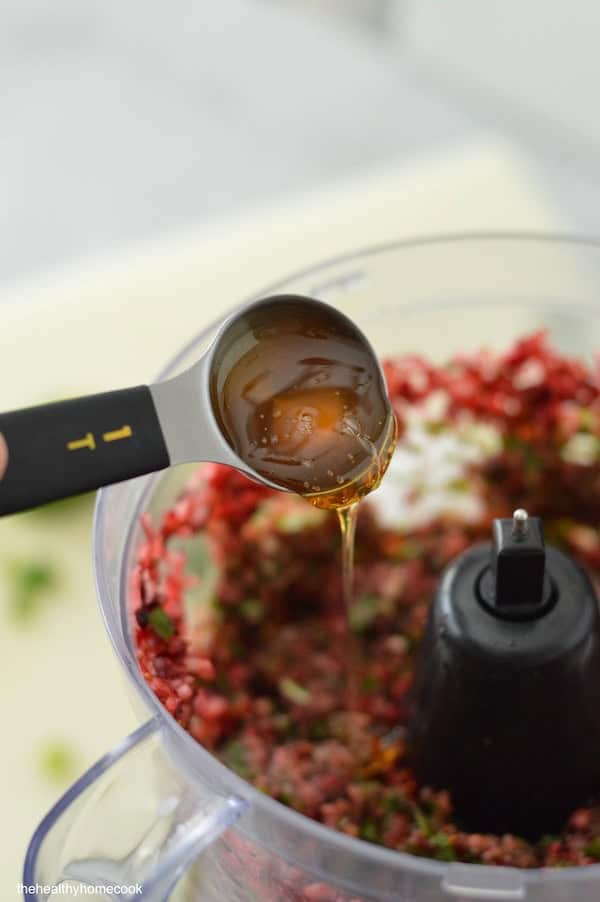 This Spicy Cranberry Salsa is easy to make and full of holiday flavor! Save this recipe for a crowd-pleasing dip.