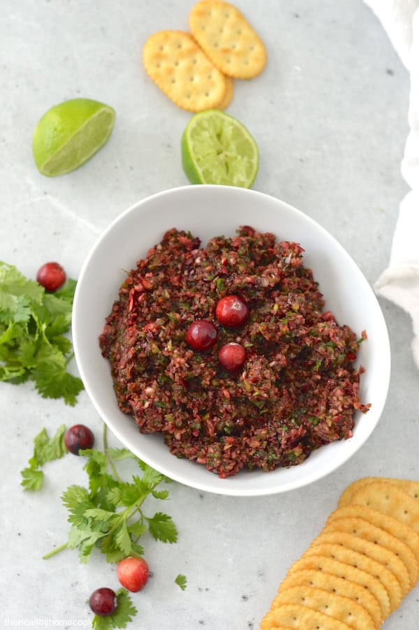 This Spicy Cranberry Salsa is easy to make and full of holiday flavor! Save this recipe for a crowd-pleasing dip.