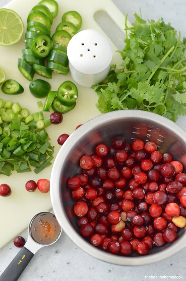 This Spicy Cranberry Salsa is easy to make and full of holiday flavor! Save this recipe for a crowd-pleasing dip.