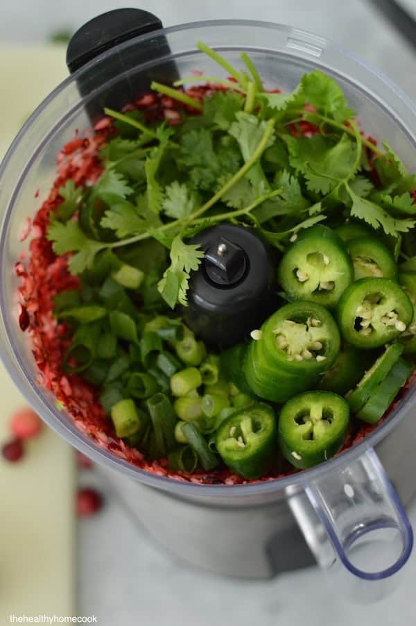This Spicy Cranberry Salsa is easy to make and full of holiday flavor! Save this recipe for a crowd-pleasing dip.