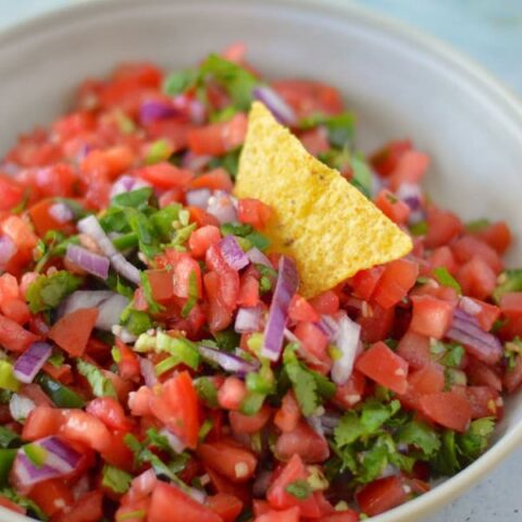 This fresh Pico de Gallo is the perfect dip for tacos, chips, and more! Learn how to make this easy recipe in less than 10 minutes!
