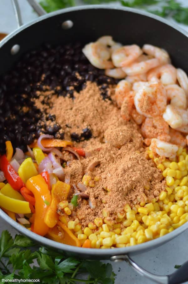 This easy Shrimp Taco Bowl with beans, veggies and spices is the ultimate weeknight family dinner—no mess, no stress!