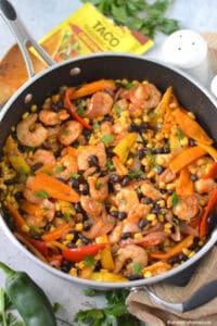 This easy Shrimp Taco Bowl with beans, veggies and spices is the ultimate weeknight family dinner—no mess, no stress!