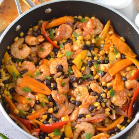 This easy Shrimp Taco Bowl with beans, veggies and spices is the ultimate weeknight family dinner—no mess, no stress!