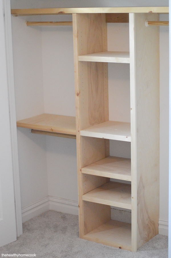 Process shot of closet being build, frame intact, unpainted wood.