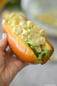 Close shot of hand holding Curried Shrimp Rolls.