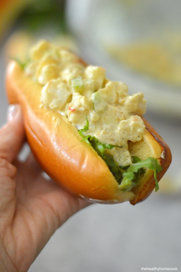 Close shot of hand holding Curried Shrimp Rolls.