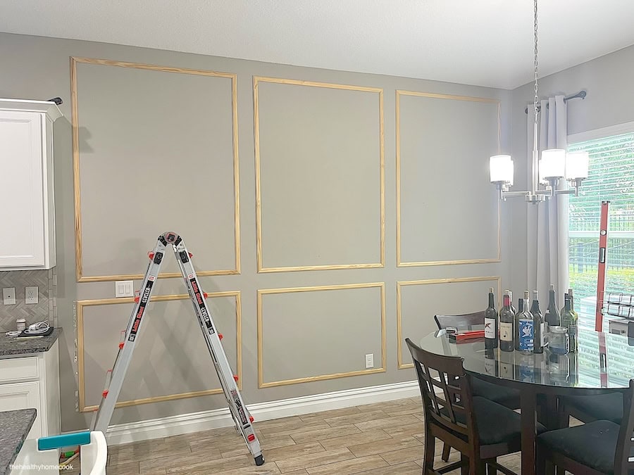 Process image of all wooden molding attached to wall. Two rows of three boxes.