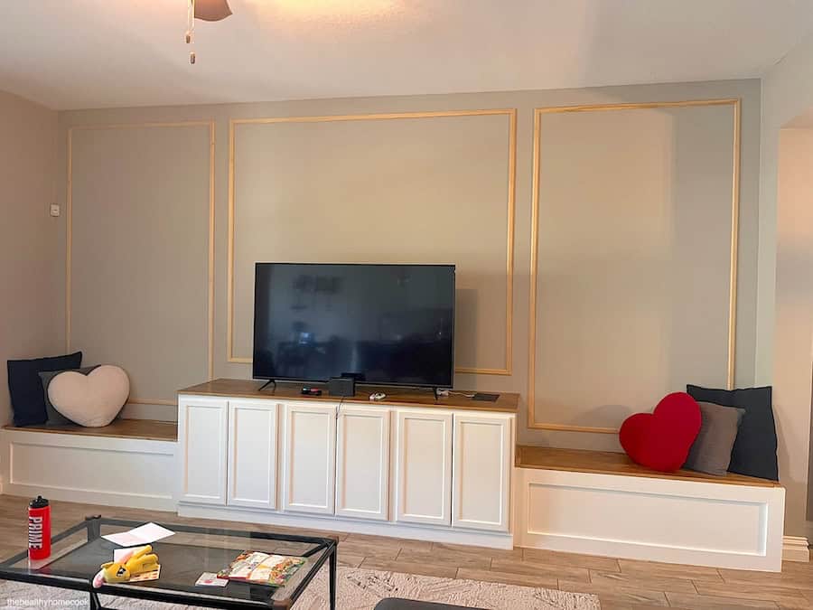 Process image of wall trim attached in the living room area around build in entertainment center.
