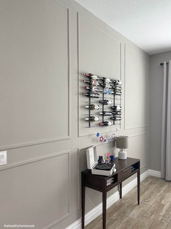 Final image of Picture Frame Molding in Dinette with wine racks and console table.