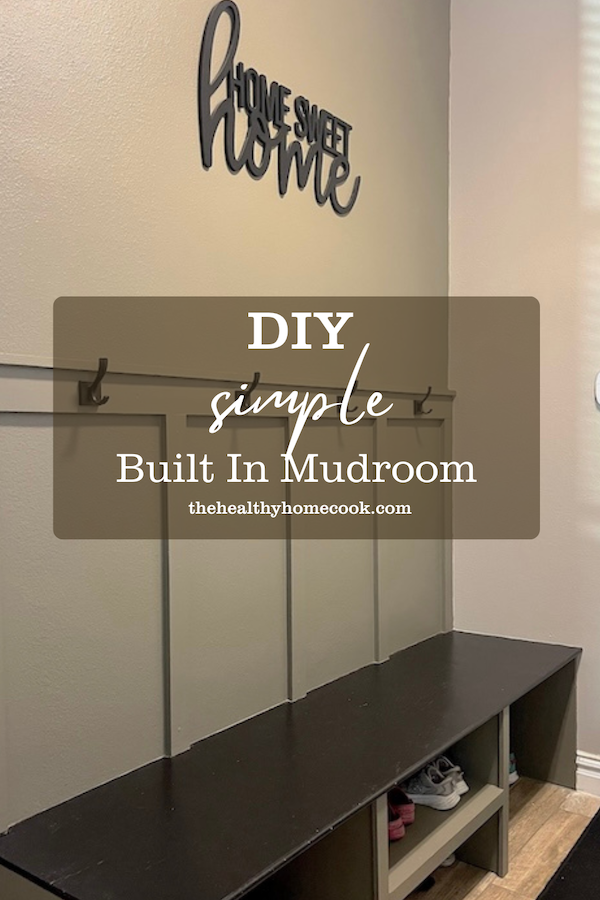 Profile image of final mudroom. Tan walls and black bench.
