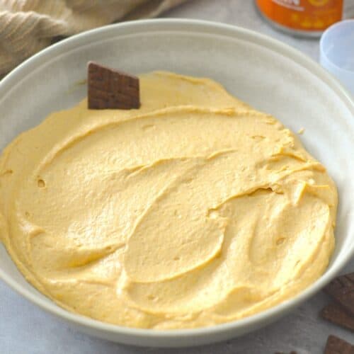 Overhead shot of Creamy Pumpkin Protein Dip with chocolate crackers around and dipped in.