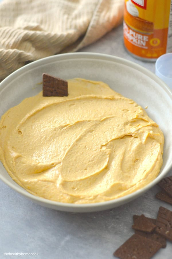 Overhead shot of Creamy Pumpkin Protein Dip with chocolate crackers around and dipped in.